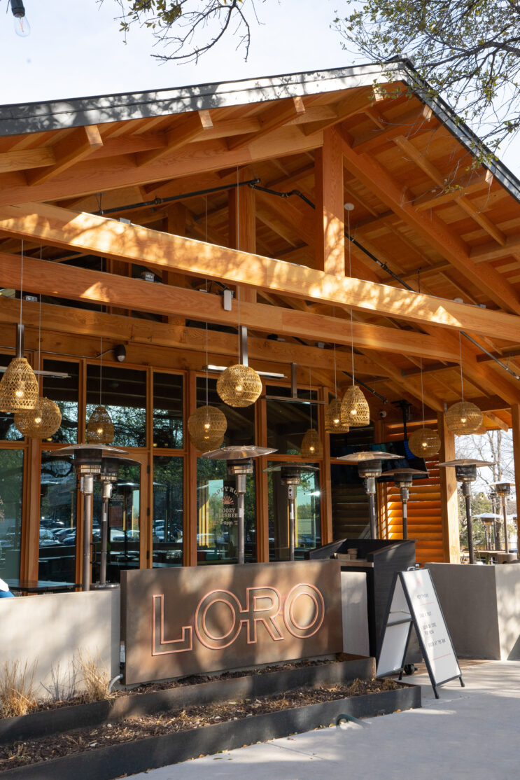 The exterior, sign, and outdoor patios of Loro Addison.