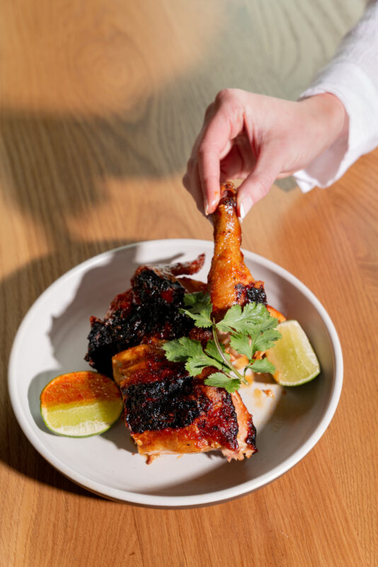 Sake can chicken served on a white plate.