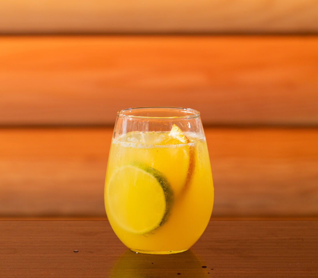 A yuzu spritz cocktail served in a glass.