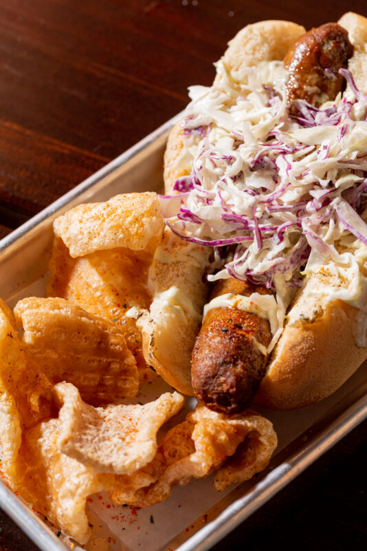 A close-up of Thai curry sausage served on a metal tray.