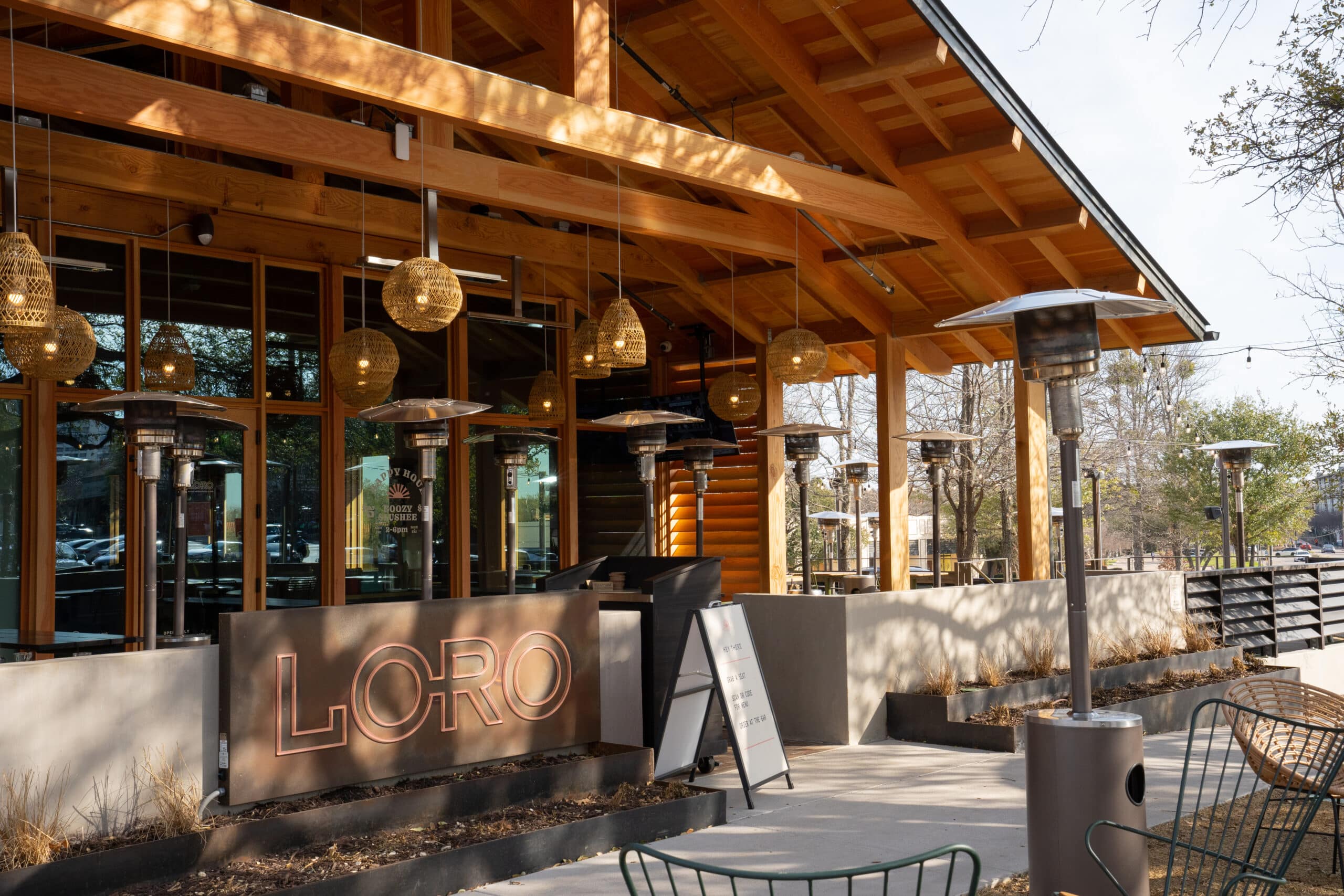 The exterior, sign, and outdoor patios of Loro Addison.