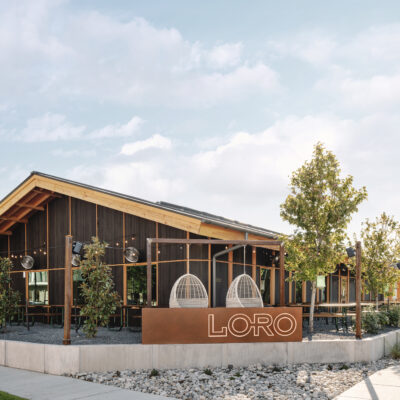 The exterior, sign, and outdoor patios of Loro Dallas East.