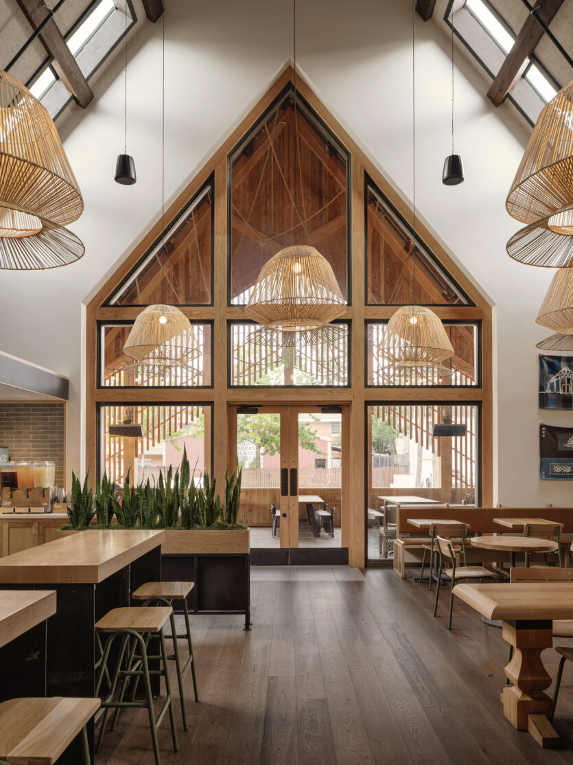 A wide angle view of the dining room and the main entrance at Loro Houston Heights.