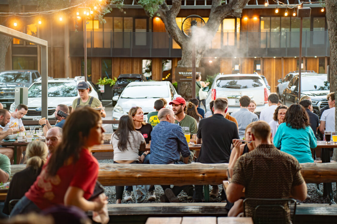 people on the loro patio with misters to keep cool