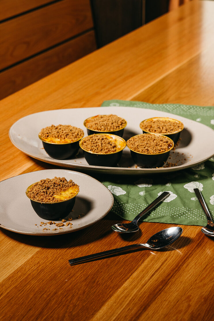 6 mini cheesecakes on a plate with crumble and yuzu marmalade topping