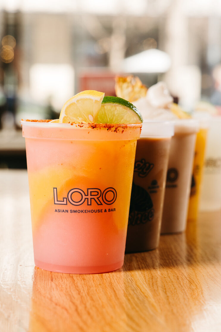 line of boozy slushees, colorful and garnished with lime