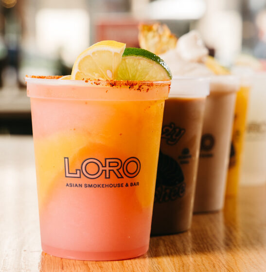 line of boozy slushees, colorful and garnished with lime