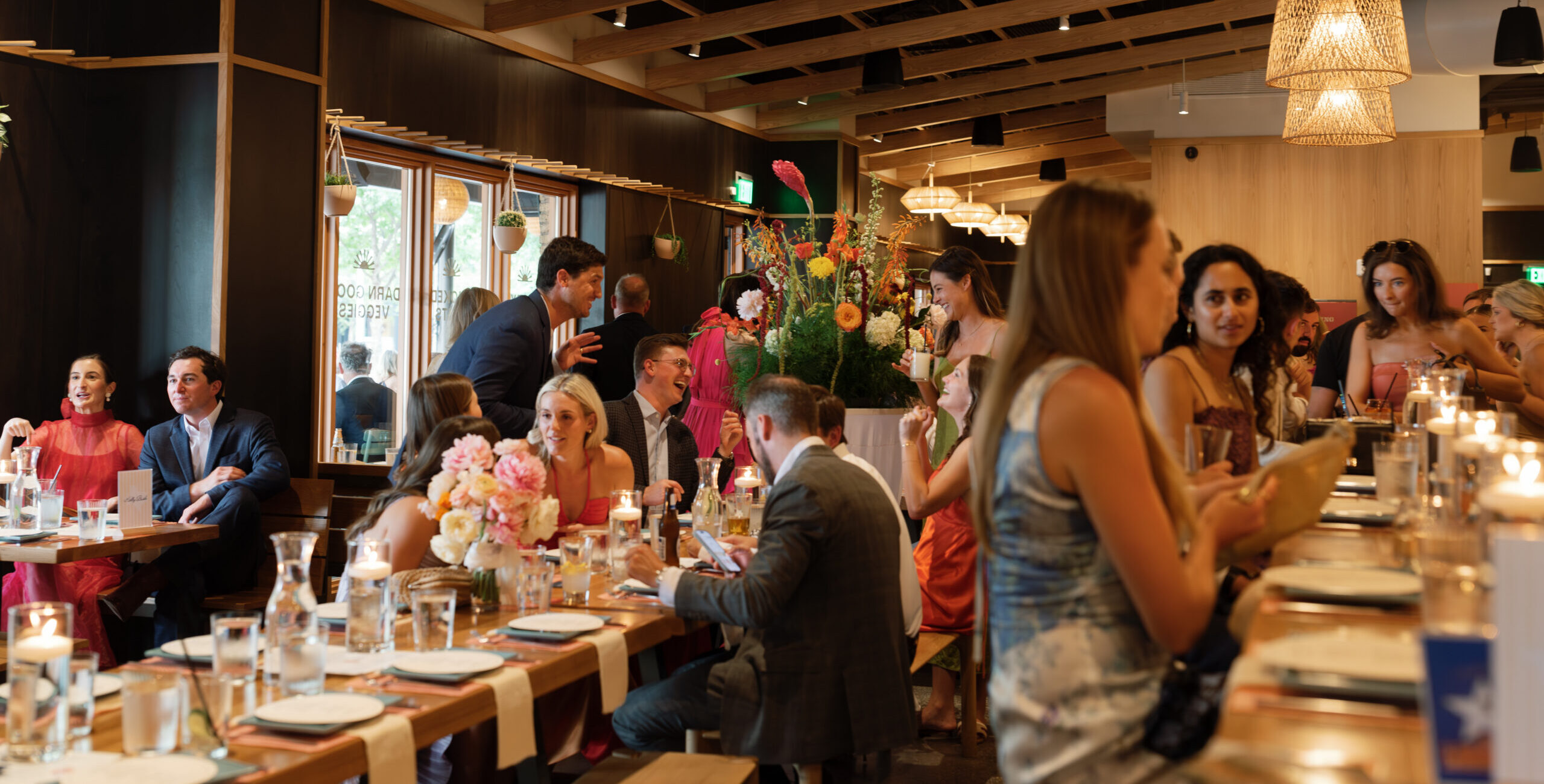 Guests enjoying a wedding reception hosted at Loro with pretty place settings and floral decorations