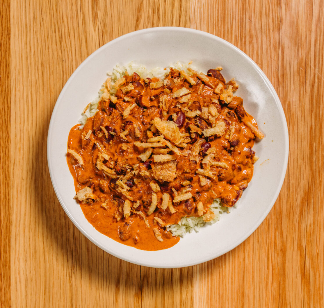 red curry with beans over rice topped with crispy onions