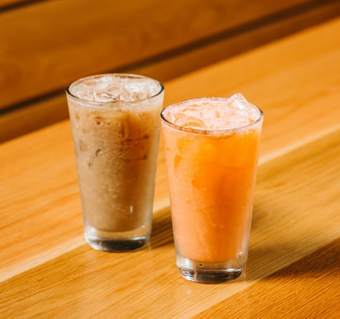 two creamy sodas one with orange Fanta and one with Dr Pepper